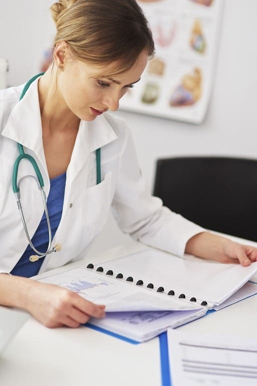 female-doctor-reviewing-the-medical-record female-doctor-reviewing-the-medical-record